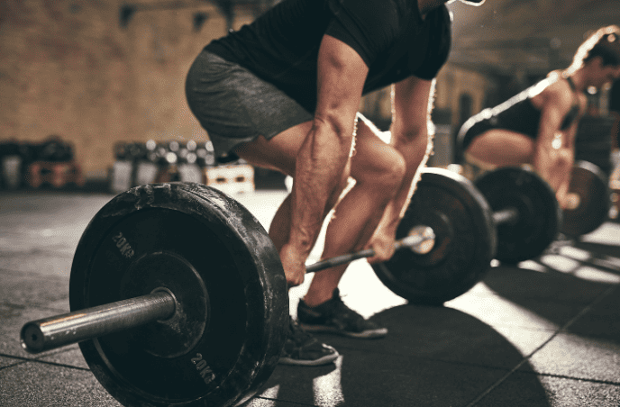 Ft people doing deadlift exercise in gym